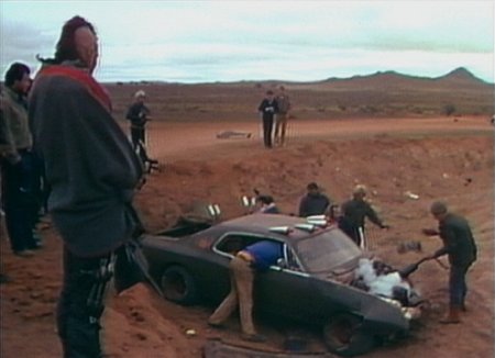 Max Aspin is removed from the car, while it is made safe